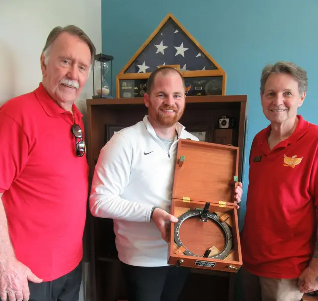 Joe McVay and Curt Rowlett, Board of Directors presented the 1940s Brass Bearing Circle to Troy Bolibar, Director of Veterans Afire of FGCU