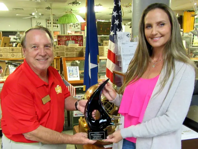 Dave Hinds presenting Glass Sculpture to Tiffany Schank, Executive Director of Marine Industries Association of Collier County