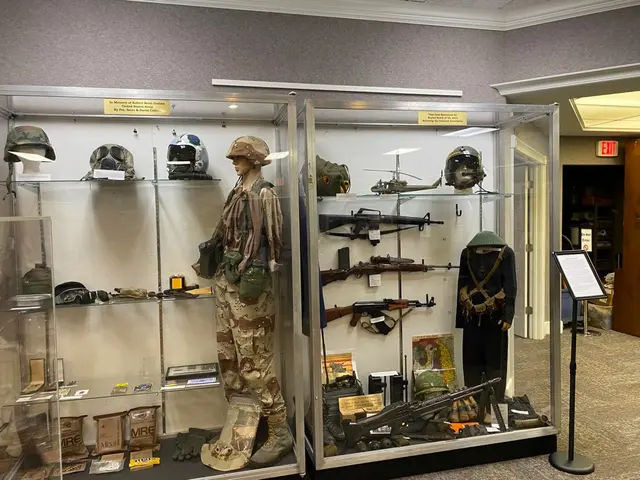 Display cases with a desert camouflage uniform, helmets, field rations and rifles