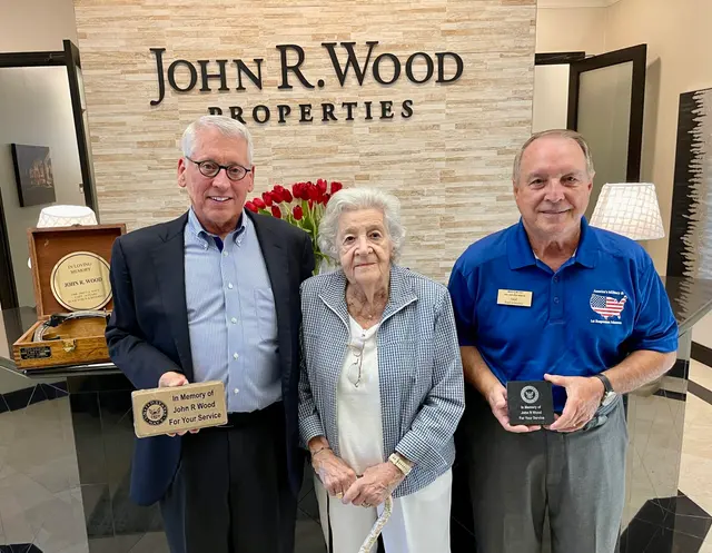 Dave Hinds, president of the Military Museum, presenting Bearing Circle and Paver to Phil Wood, son of the late John R. Wood with guest Thelma Hodges