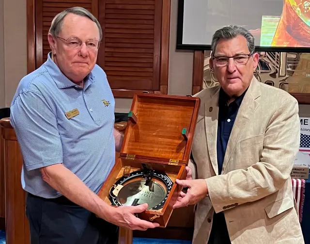 Board member Sal Marranca presenting a new 1940’s brass US Navy Bearing Circle to the Commodore of the Naples Sailing and Yard Club
