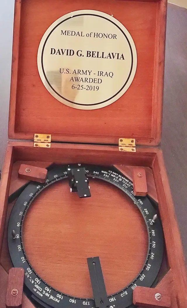 A solid brass US Navy bearing circle in a wooden presentation box with an engraved plaque
