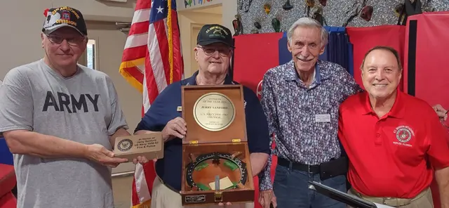 Docents, Mike and Kent presenting Bearing Circle and Memorial Paverto Jerry Sanford, Veteran of the Year 2023. Dave Hinds president in red