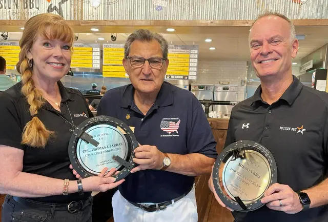 Beth, ambassador and Matt, Manager of Mission BBQ, accept plagues from Sal,Marranca Board of Director
