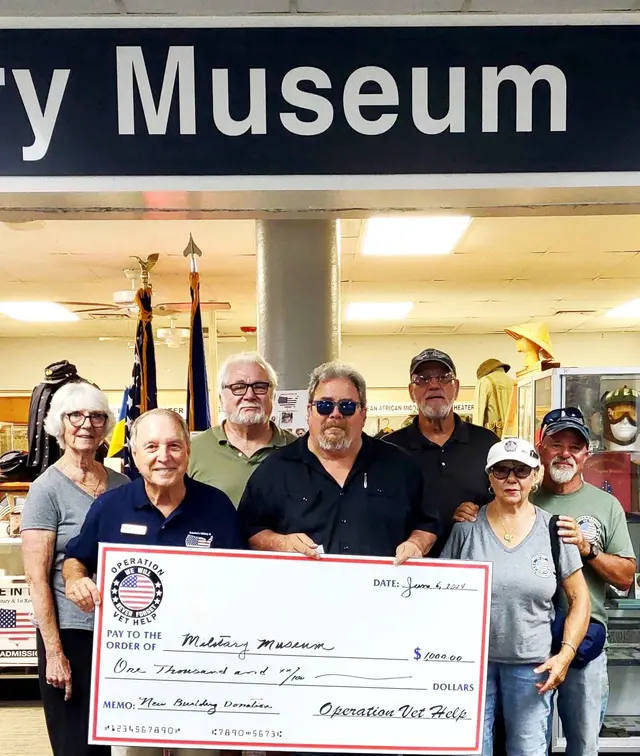 Donation received from Operation Vet Help. Front L to R – Dave Hinds, Museum president and members of Vet Help